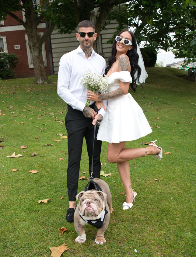 Stockport town hall wedding. bride and groom with there  family pet 